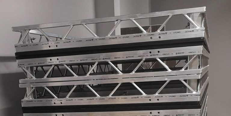 Stack of metallic truss sections with triangular support beams.